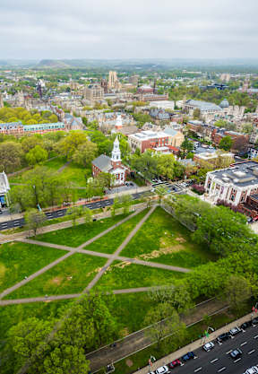 A cityscape with a large white building in the center.