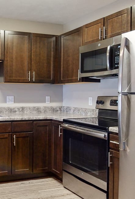 Renovated kitchen with granite counters and new appliances at Northridge Heights Apartments