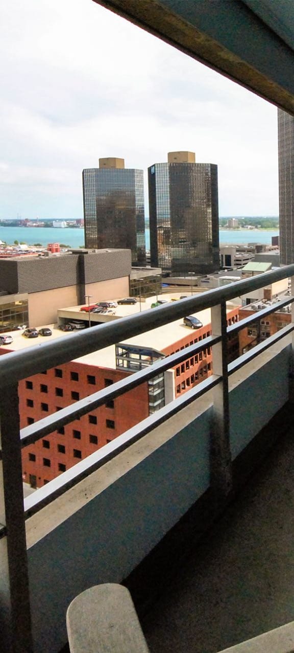 a balcony with a view of a city and the ocean