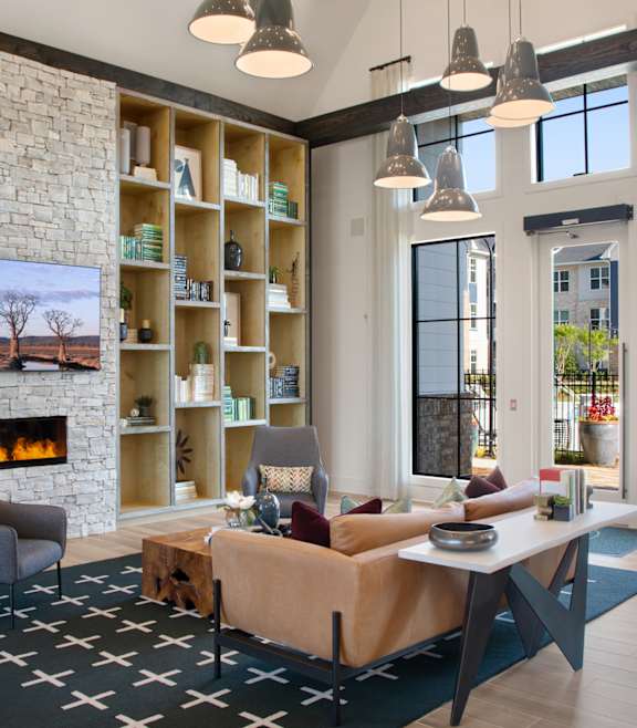 A living room with a fireplace and a painting of a tree.