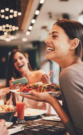A group of people enjoying a meal together in a restaurant.