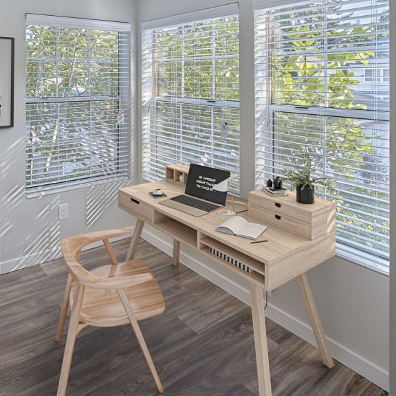 room with desk and many windows
