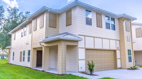 A two-story house with a garage on the ground floor.