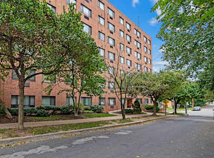 an empty street in front of a tall brick building