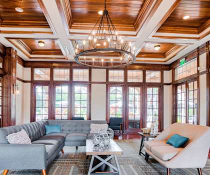 a living room filled with furniture and a large chandelier at Estates at Heathbrook, Ocala