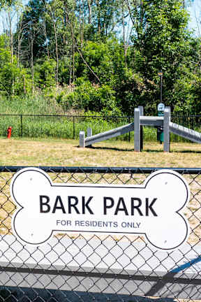 A sign on a fence reads "Bark Park for residents only".