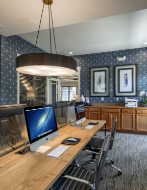 a room with a long wooden table with computers on top of it at Chesapeake Ridge, Maryland