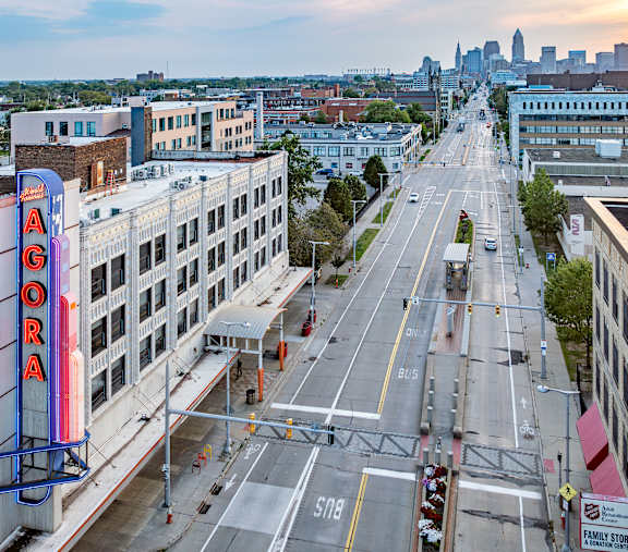 A city street with a large Aura sign on the left side.