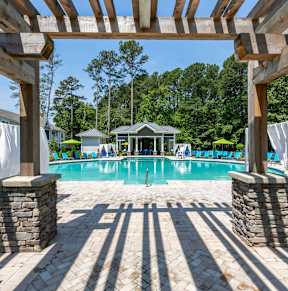a resort style swimming pool with lounge chairs and umbrellas at Linkhorn Bay Apartments, Virginia Beach, VA, 23451