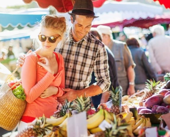 Trendy Young Couple Perusing Local Farmer's Market Produce