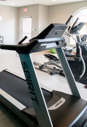 a room with a treadmill and other exercise equipment