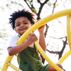 Young Boy Smiling while Playing on Playground