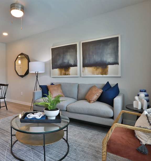 a living room with a couch and a chair and a tv
