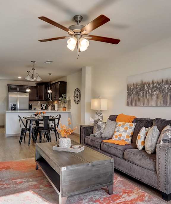 a living room with a couch and a ceiling fan