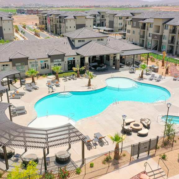 an aerial view of a large swimming pool in an apartment complex