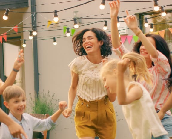 Family Dancing Together at Backyard Party