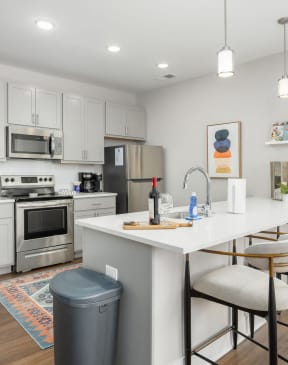 a kitchen with a large island with bar stools
