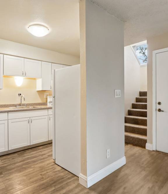 A kitchen with white cabinets and a countertop.