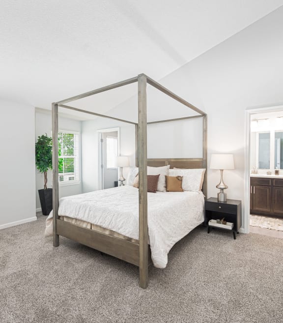 a bedroom with a four poster bed and a fireplace