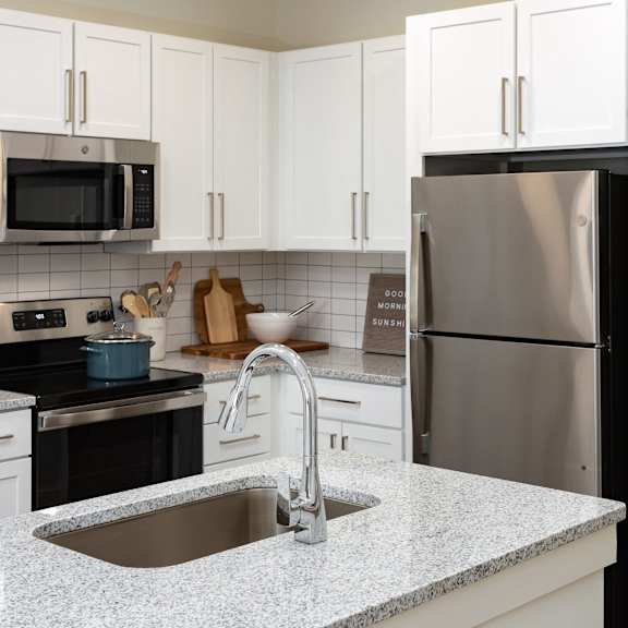 a kitchen with granite counter tops and stainless steel appliances