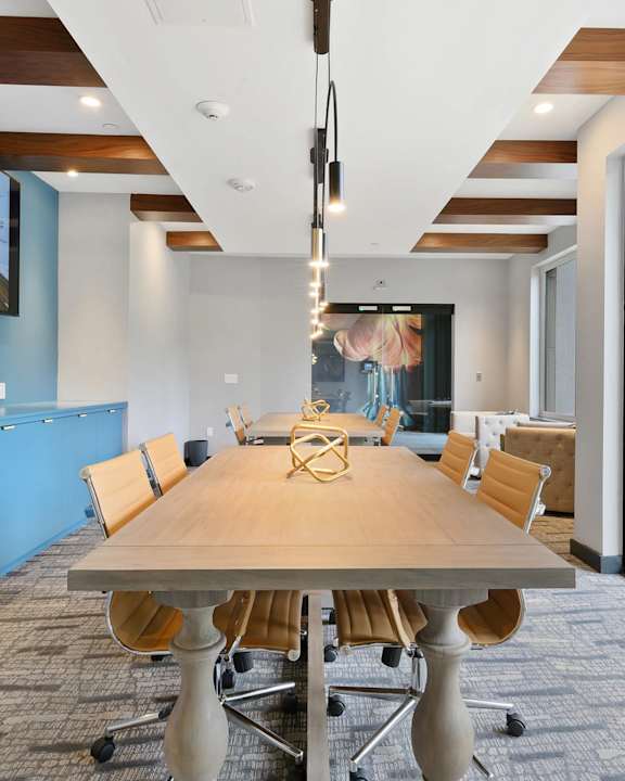 A conference room with a long table and chairs.
