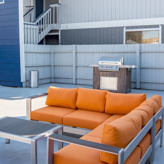 Outdoor Patio with Orange Couch at The Lakes Apartments, Moses Lake, WA.
