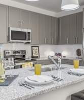 A kitchen with a countertop and a microwave above it.