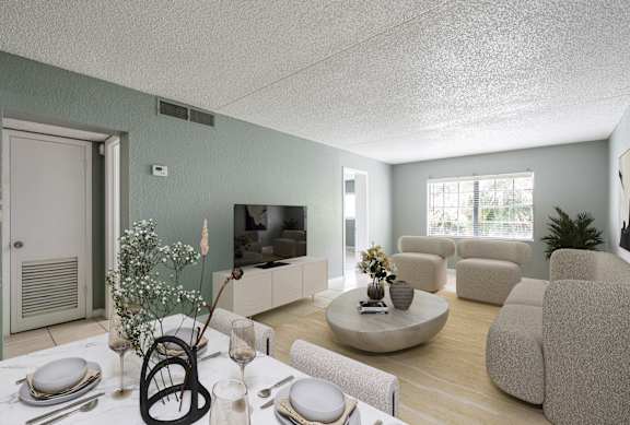 A living room with a dining table set for two and a television.