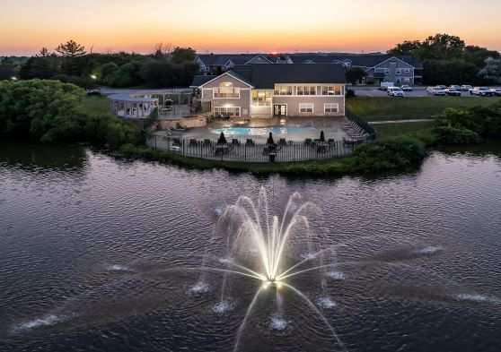 A house with a fountain in front of it.