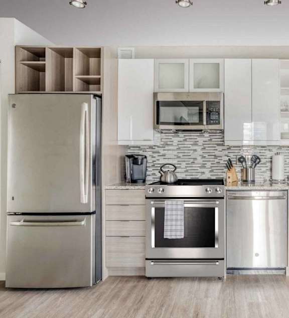 A modern kitchen with a refrigerator, oven, and microwave.at Sky Central, Cincinnati, 45202