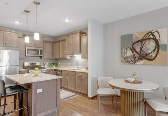 a kitchen and dining area with a stainless steel refrigerator