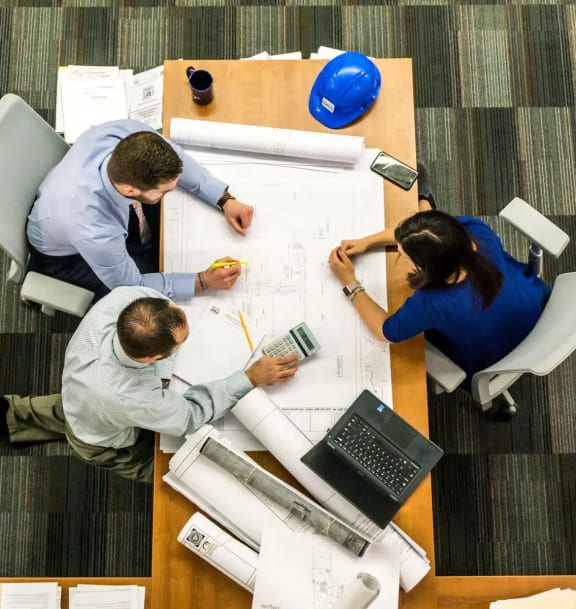 people sitting around a table in a meeting