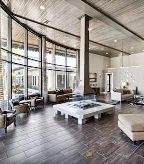 A modern living room with a large window and a flat screen TV.
