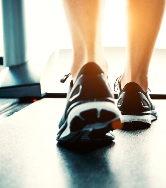 a woman in workout shoes on a treadmill at Huntington Green Apartments, University Heights, 44118