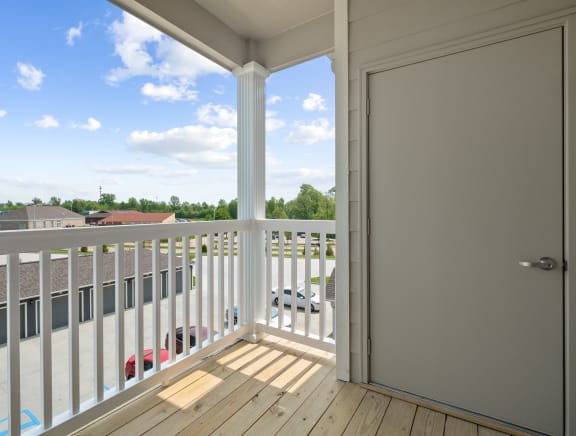 a balcony with a door and a view of a parking lot  at Aventura at Wentzville, Wentzville, 63385