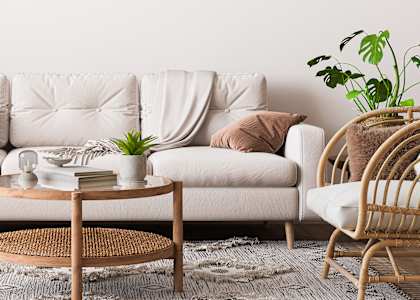 a living room with white furniture and a white wall