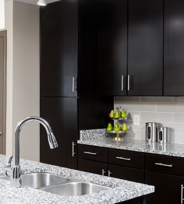 radius at the banks apartments kitchen with island granite counter tops and stainless steel appliances