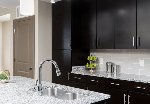 radius at the banks apartments kitchen with island granite counter tops and stainless steel appliances