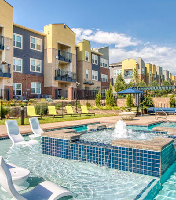 A person is floating in a pool with their arm extended.
