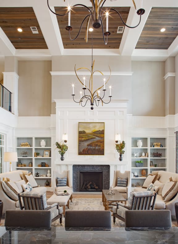 a living room with a coffered ceiling and a fireplace