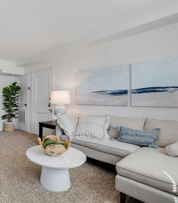 A modern living room with a blue couch and a coffee table.