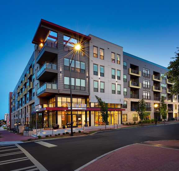 an exterior view of an apartment building at dusk