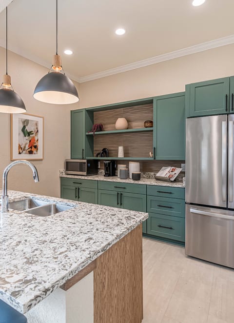 a kitchen with stainless steel appliances and a marble counter top