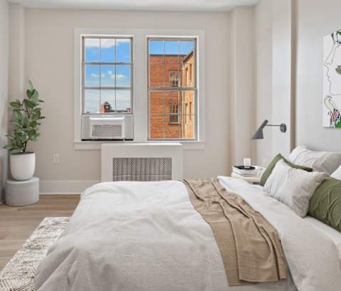 a bedroom with a large bed and a tv