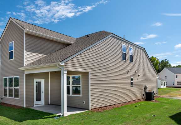 a home with vinyl siding and a green lawn