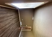 Thumbnail 4 of 17 - A stairwell with a metal railing and a light on the floor.