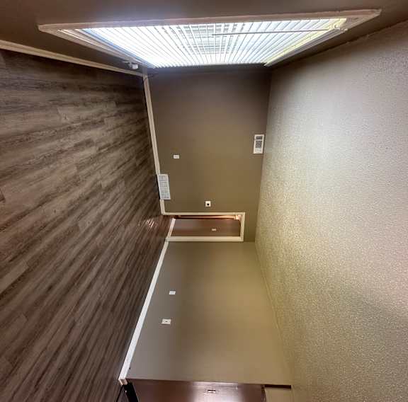 A stairwell with a metal railing and a light on the floor.