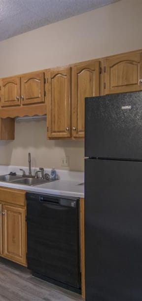 a kitchen with white cabinets and a black stove and refrigerator