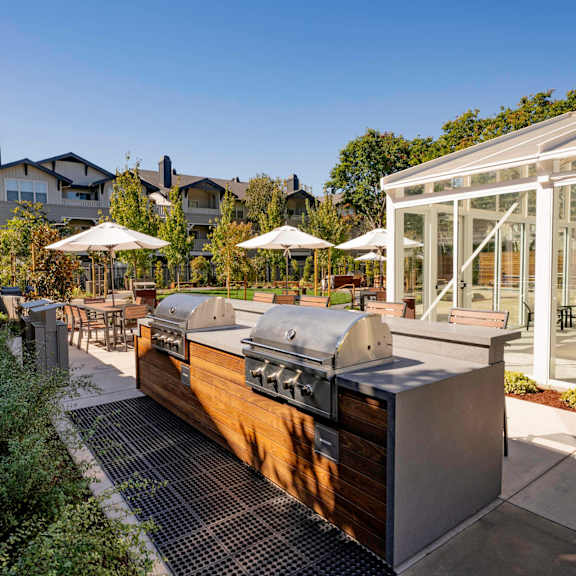 A pool area with a chair and table overlooking a body of water.