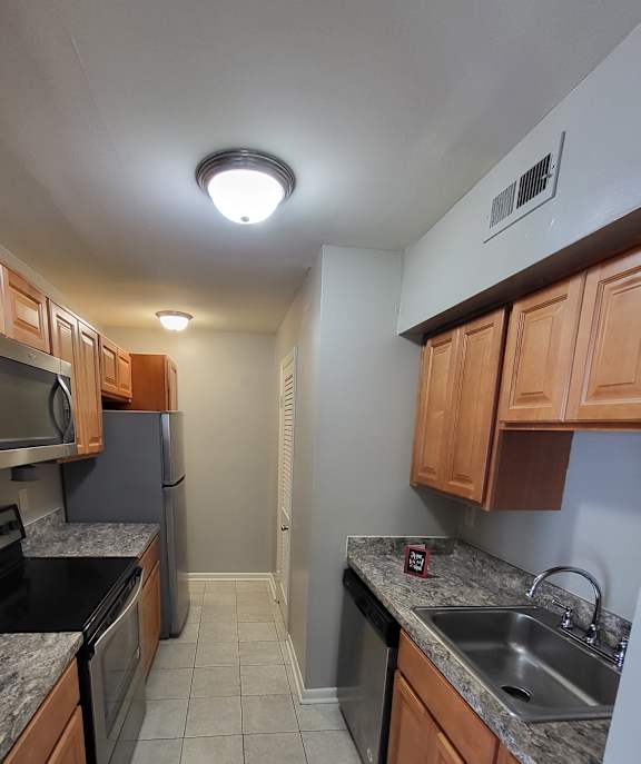 a kitchen with a stove top oven next to a sink